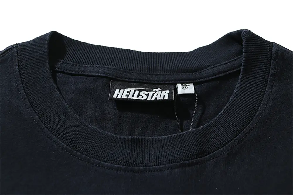Close-up of the T-shirt's neckline tag, showcasing wash care instructions and brand details in a fashion design.