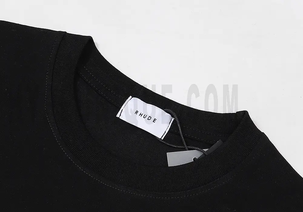 Neckline tag close-up, displaying garment care symbols and brand information with fashion-forward presentation.