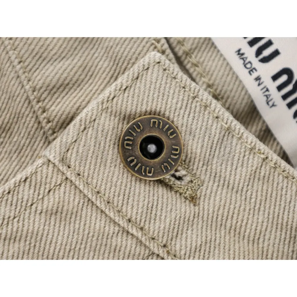 Close-up of button detail on the pants