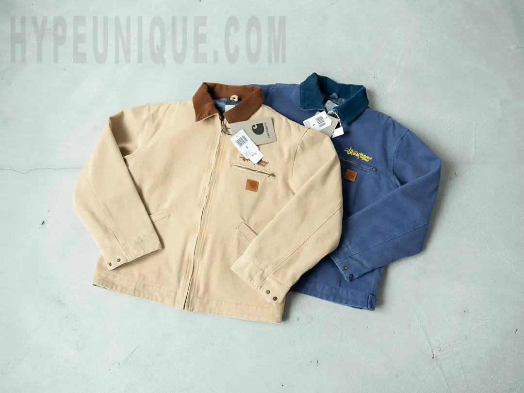 Carhartt X Stussy J97 Jacket in beige and blue front view.