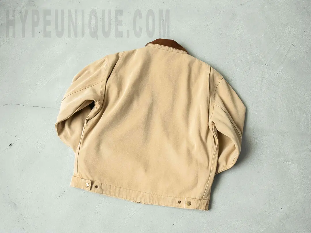 Carhartt x Stussy J97 Jacket Beige front view. Showing the Stussy logo on the left chest.