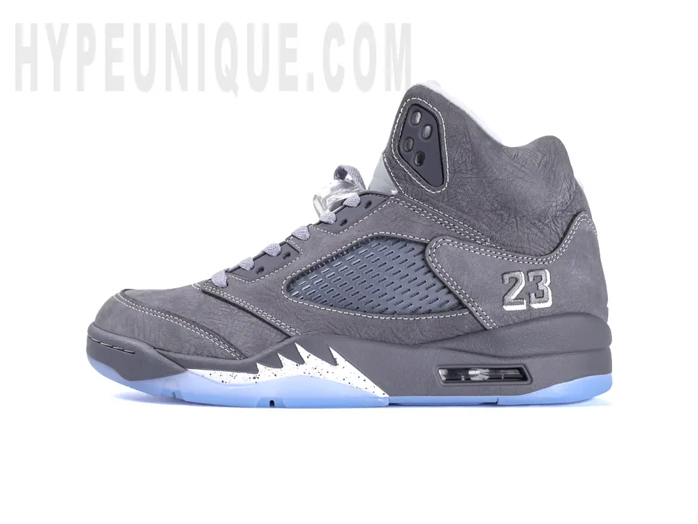 Left lateral side view of the Jordan 5 ‘Wolf Grey’, highlighting the grey suede upper and translucent blue icy outsole.