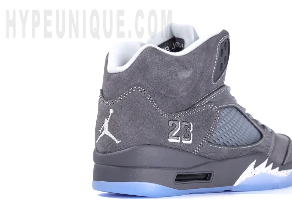 Rear-right view of the Jordan 5 ‘Wolf Grey’, highlighting the grey upper and the embroidered “23” logo.