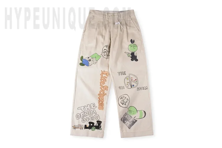 Front view of the KAPITAL Ivy Wide-Leg Pleated Printed Cotton-Corduroy Trousers.