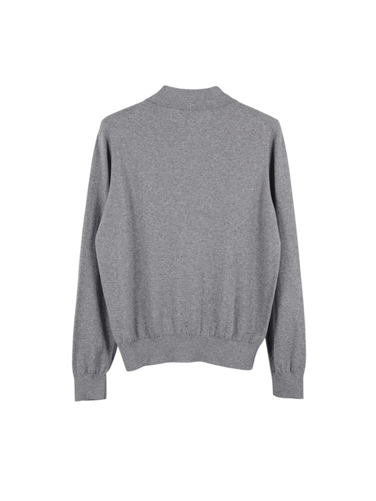 Gray knit sweater viewed from the back, featuring long sleeves, ribbed cuffs, and hem. Soft texture with subtle marl pattern.
