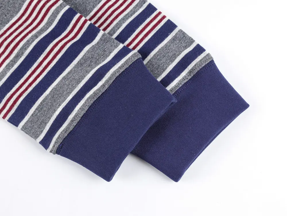 Cuffed sleeves with navy fabric, gray, red, and white stripes. Soft texture and horizontal lines create a cozy look.