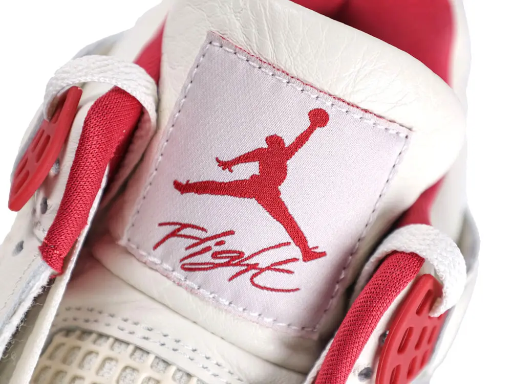 White foam insoles with red graphic prints, featuring lip and jumpman designs.