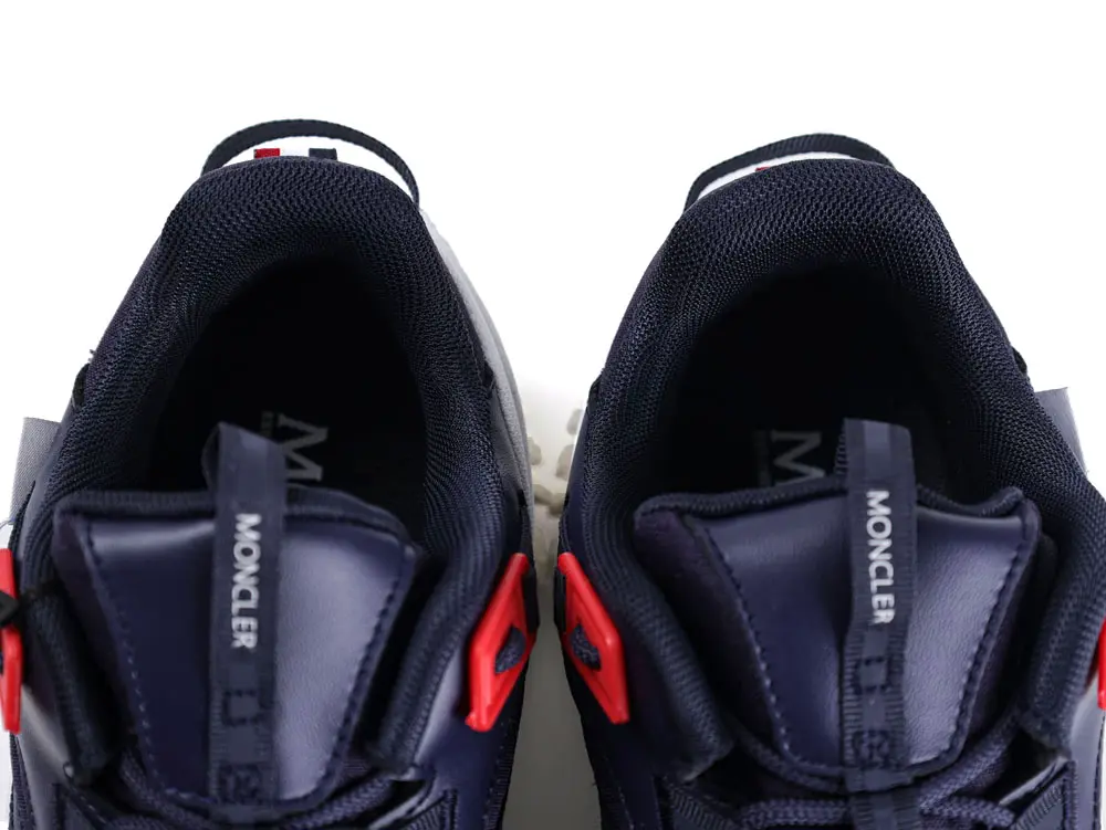Navy and red sneakers with mesh and leather upper, showing inside top view.