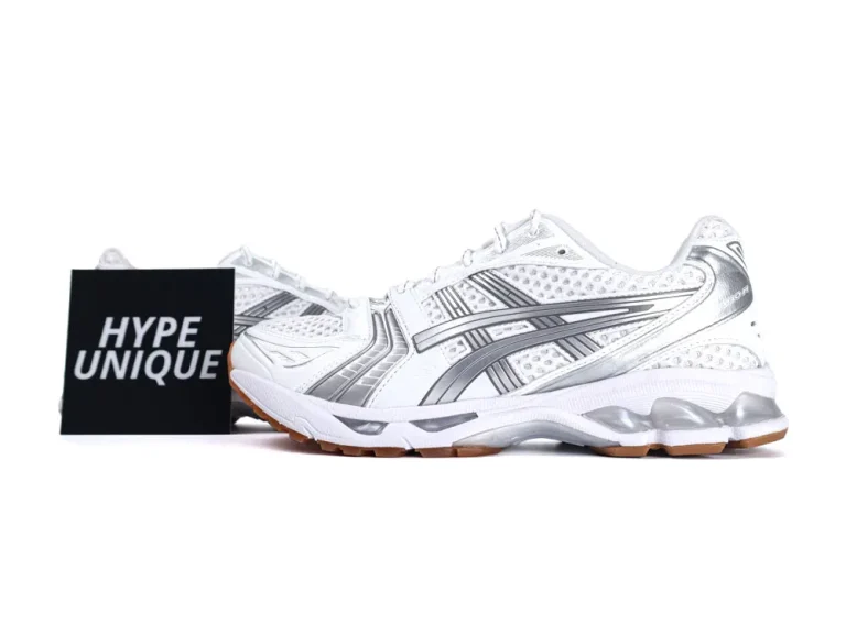 White and silver sneakers with mesh upper and rubber sole, side branding visible.