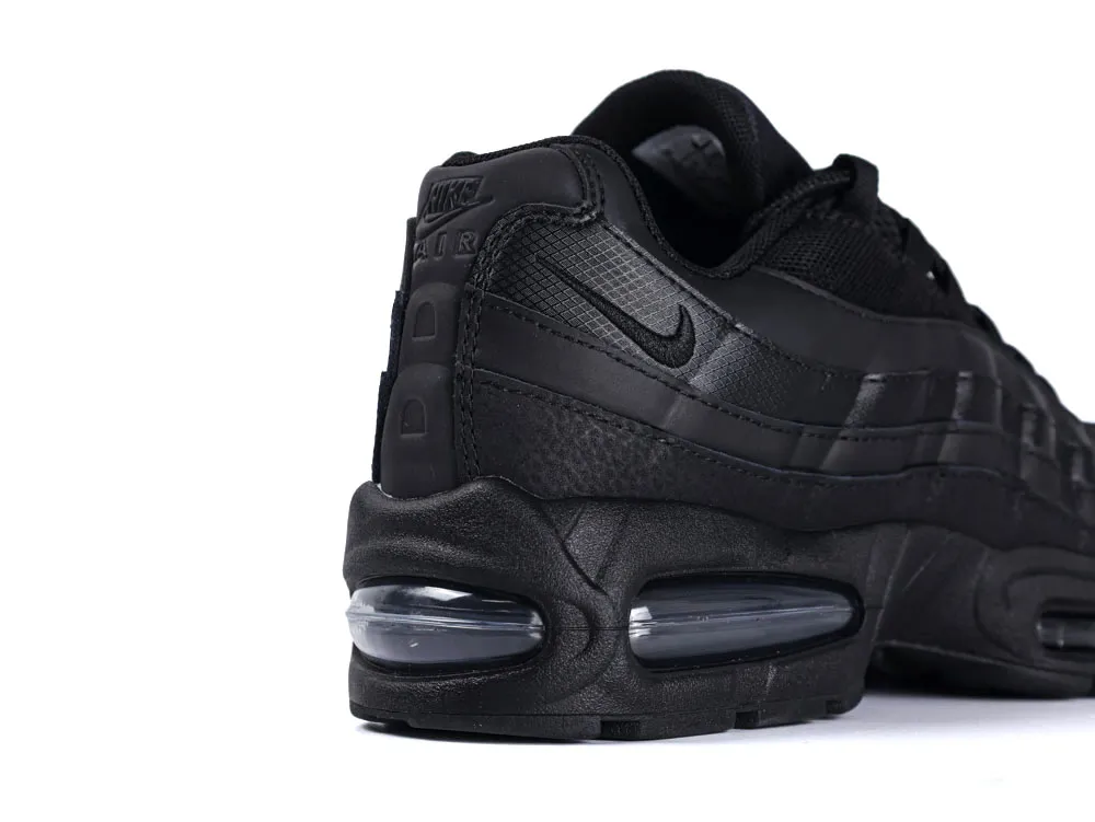 Black sneaker with leather and mesh material, featuring visible air cushioning unit.
