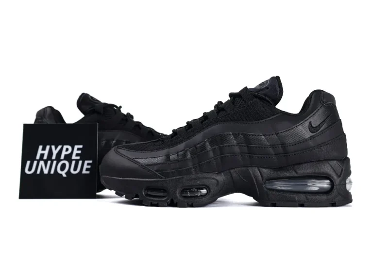Black sneakers featuring mesh and leather materials with visible air cushioning in the sole.