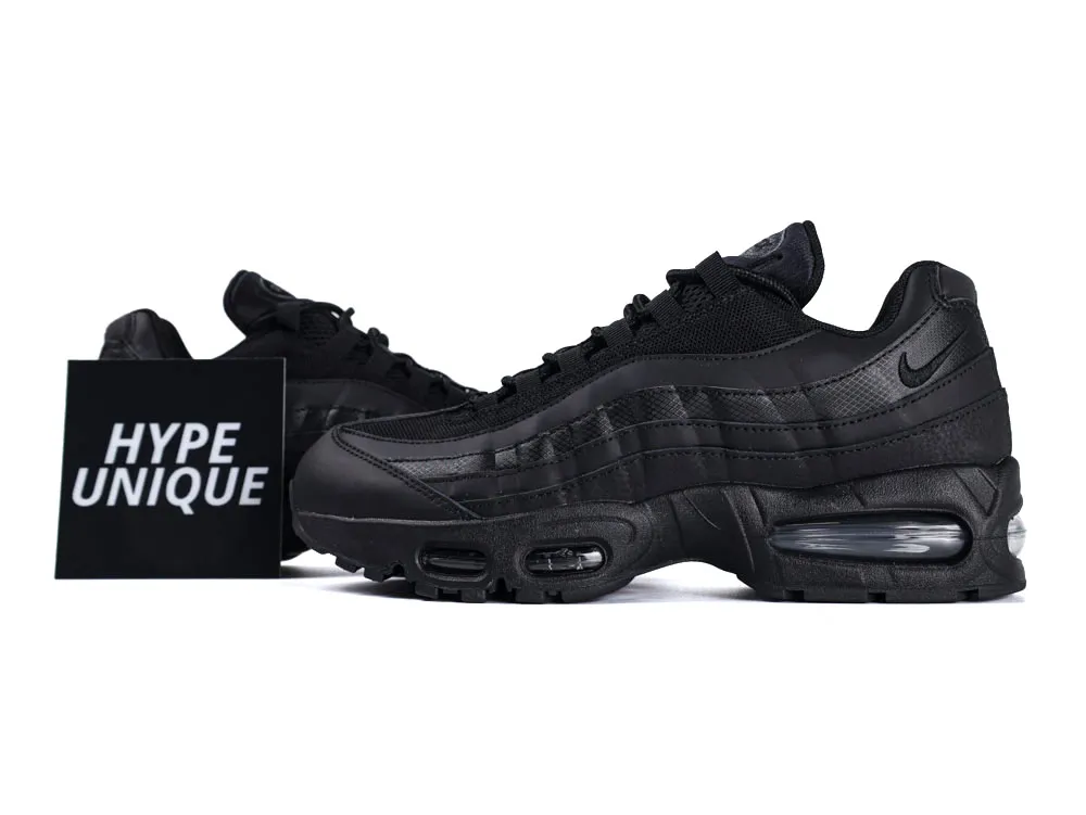 Black sneakers featuring mesh and leather materials with visible air cushioning in the sole.
