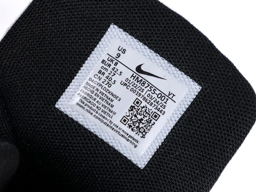 Black fabric shoe tongue with a label featuring size and manufacturing details.