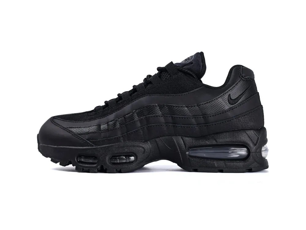 All-black sneaker with mesh upper and synthetic leather accents, featuring air-cushioned sole.