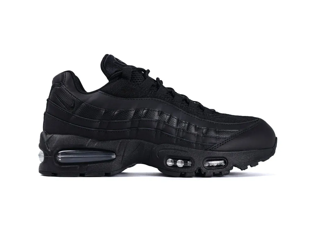 Black sneaker with mesh and leather materials, featuring an evident air-cushion sole.
