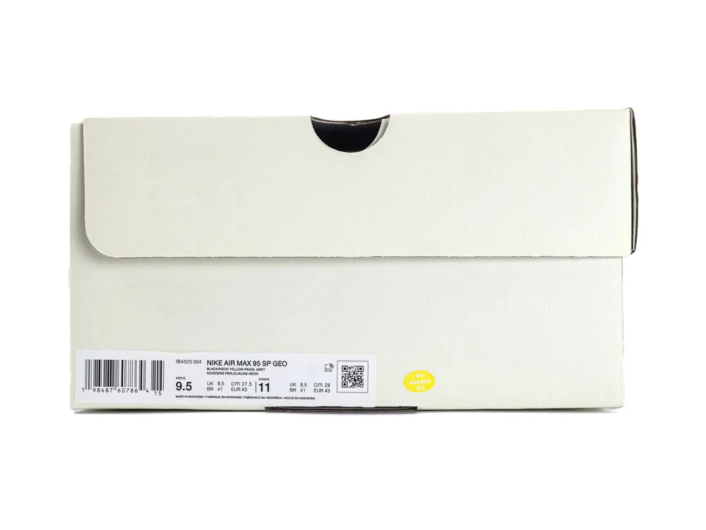 Gray suede sneaker with neon yellow accents and black sole, showcasing sleek design.