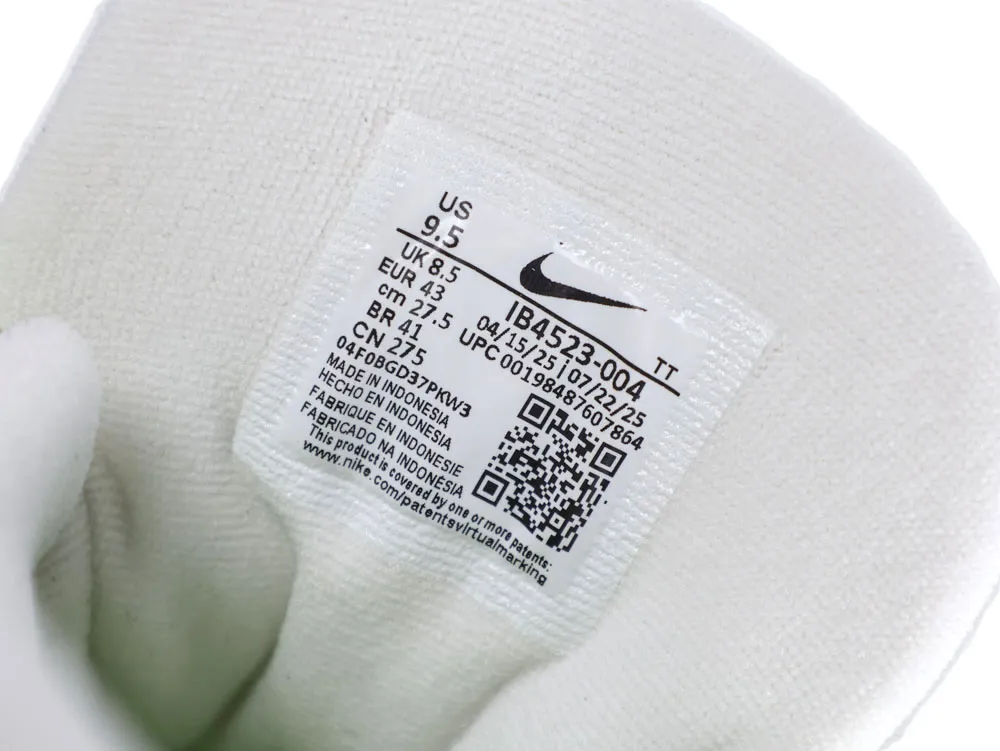 White fabric shoe tongue with a sewn-in label displaying size and manufacturing details.