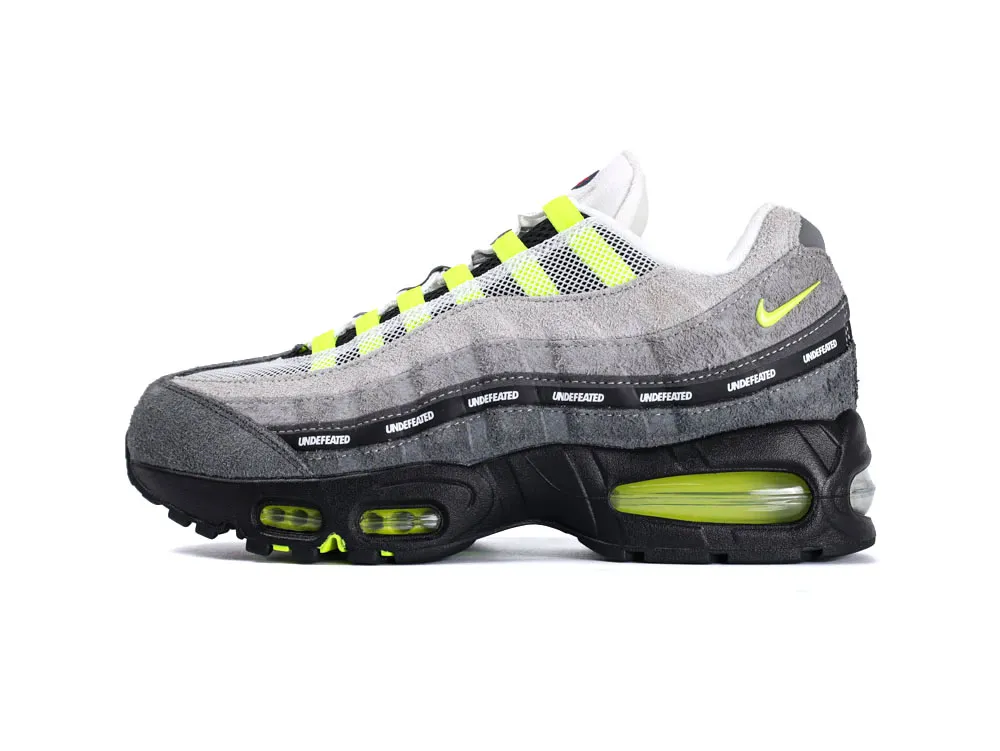 Gray suede sneaker with neon yellow accents and black sole.