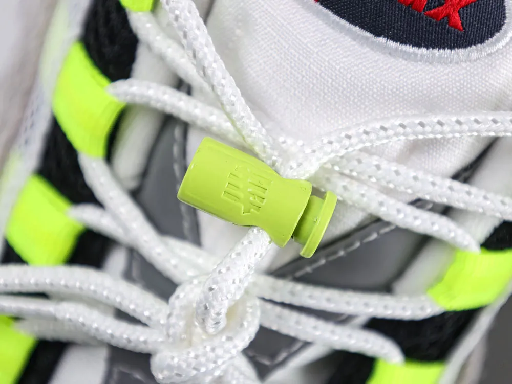 Close-up of a neon green plastic lace toggle on white and black sneaker.