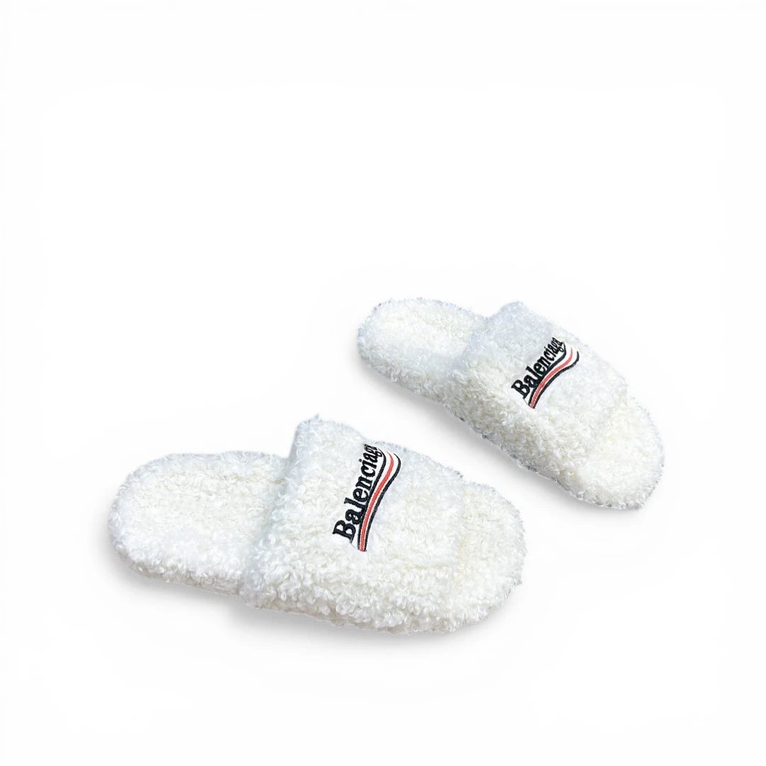 Pink fluffy slippers with embroidered logo on the upper, providing comfort and style.