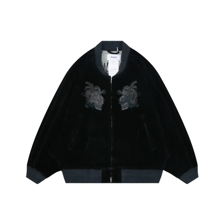 Black velvet jacket with gray ribbed cuffs, featuring embroidered designs on the chest.