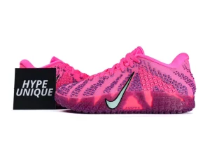 Bright pink fabric sneakers with textured pattern and contrasting black logo on the side.