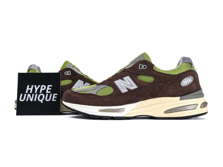 Brown and green suede sneakers with mesh detailing and cushioned sole.