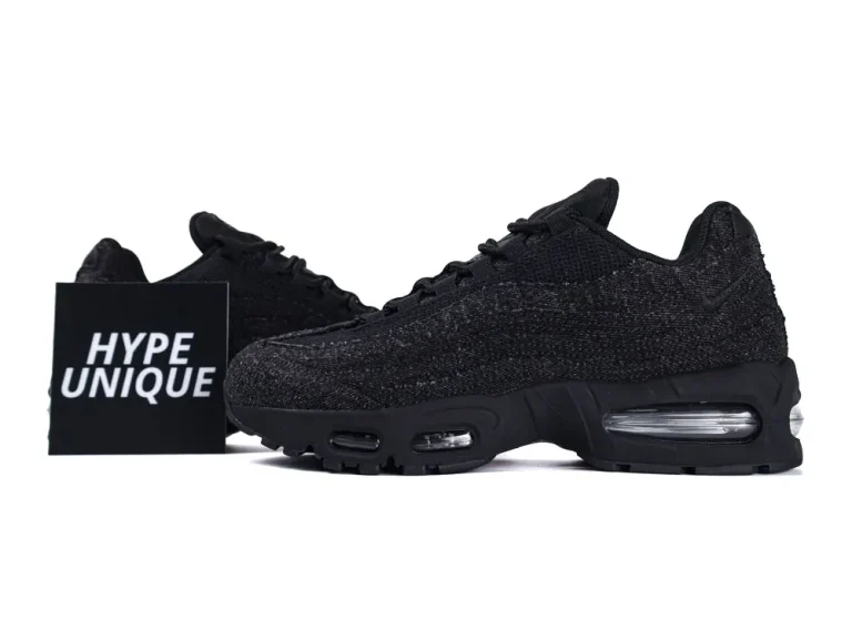 Black mesh sneakers with visible air cushioning in the sole, displayed on white background.