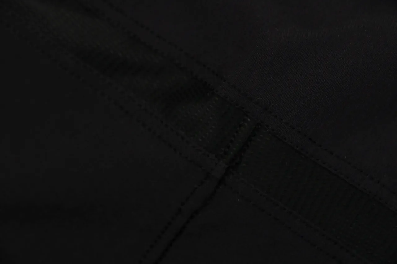 Black fabric with stitched seams, showcasing detailed craftsmanship and robust material.