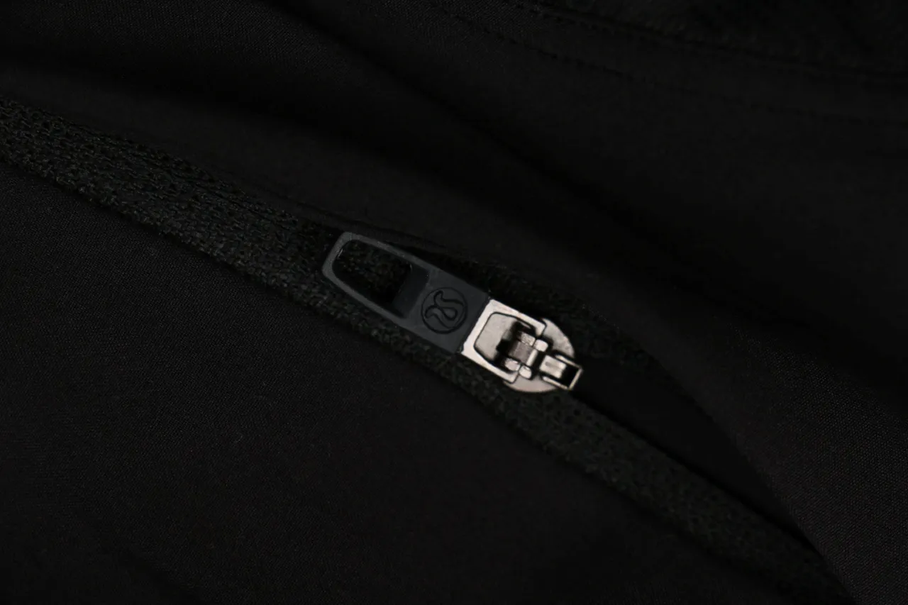 Black fabric with metal zipper detail on shorts
