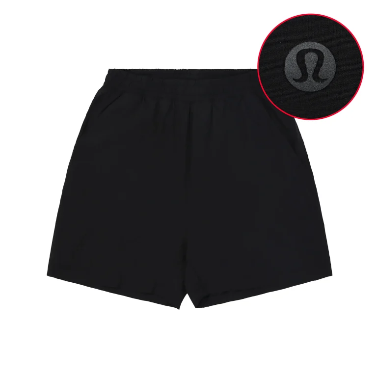 Black polyester shorts with elastic waistband and icon detail on fabric.