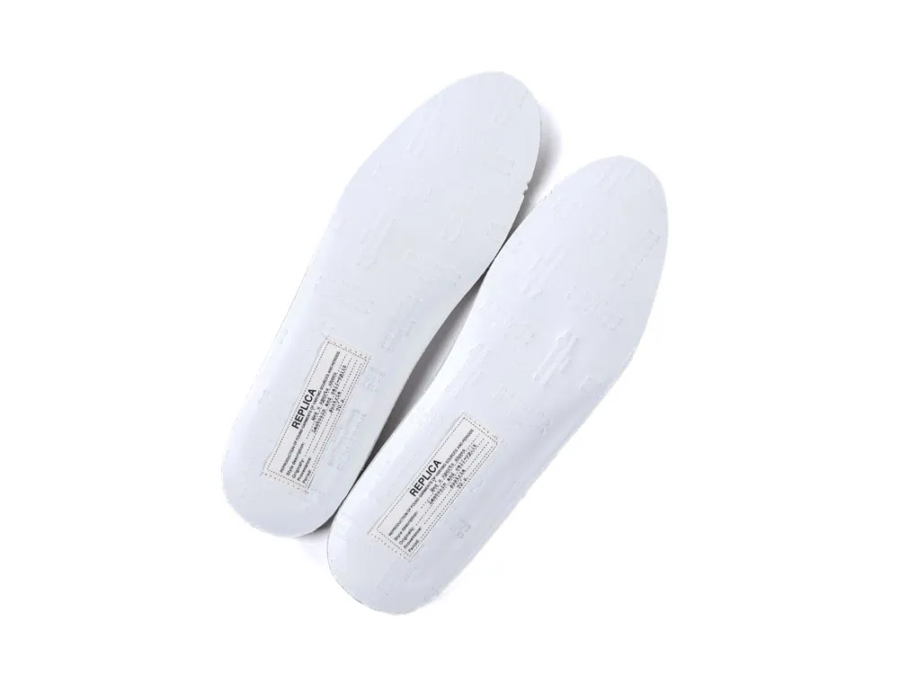 White synthetic insoles with printed labels and embossed details, viewed from above.