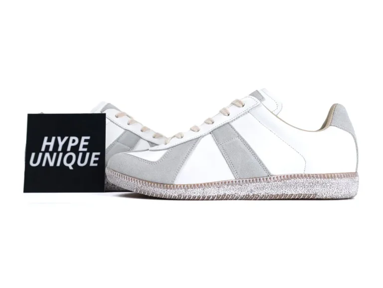 White leather and grey suede sneakers with textured rubber sole and beige laces.