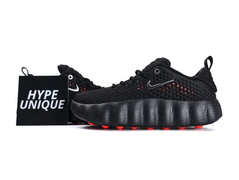 Black sneaker with textured material, featuring a unique cushioned sole and red accents.