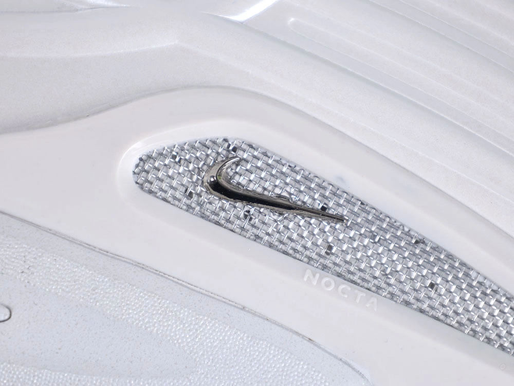 Side profile of sleek all-white sneakers showcasing wavy synthetic overlays and visible Air unit.