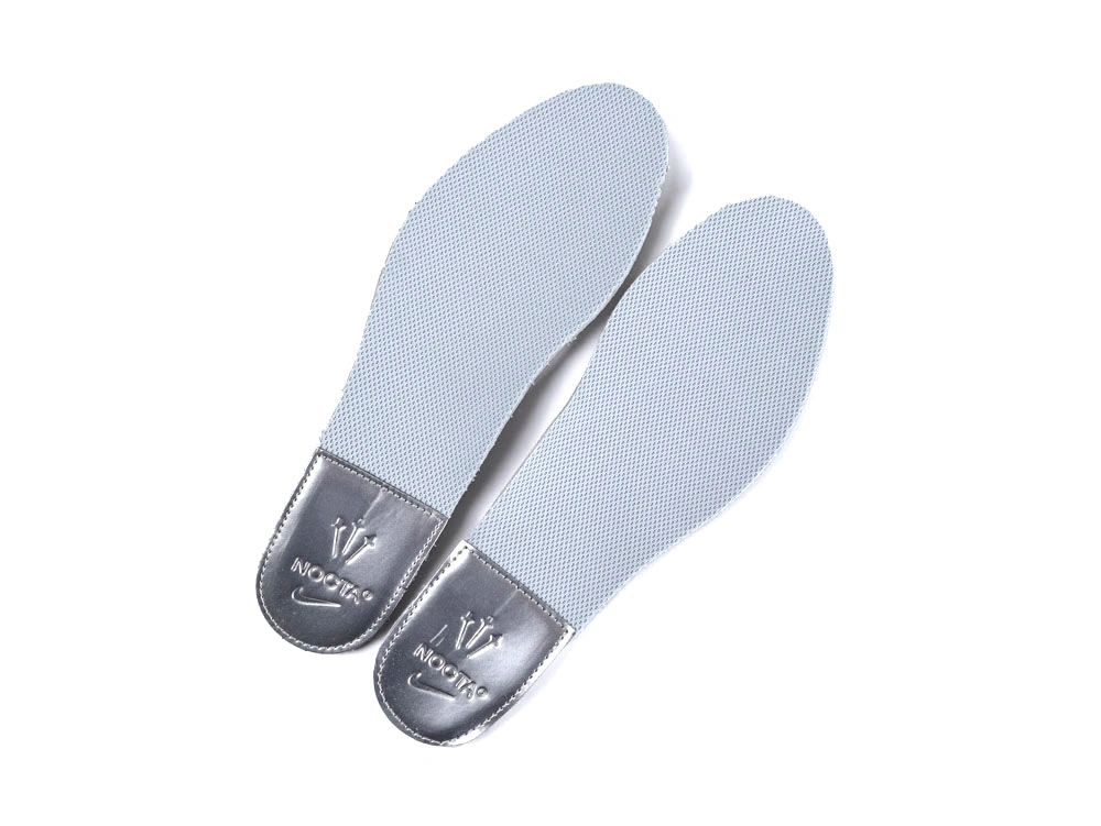 Side profile of sleek all-white sneakers showcasing wavy synthetic overlays and visible Air unit.
