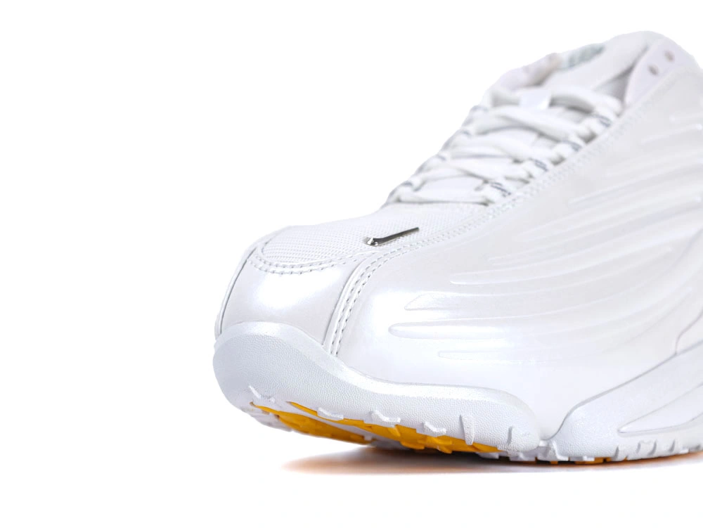 Side profile of sleek all-white sneakers showcasing wavy synthetic overlays and visible Air unit.