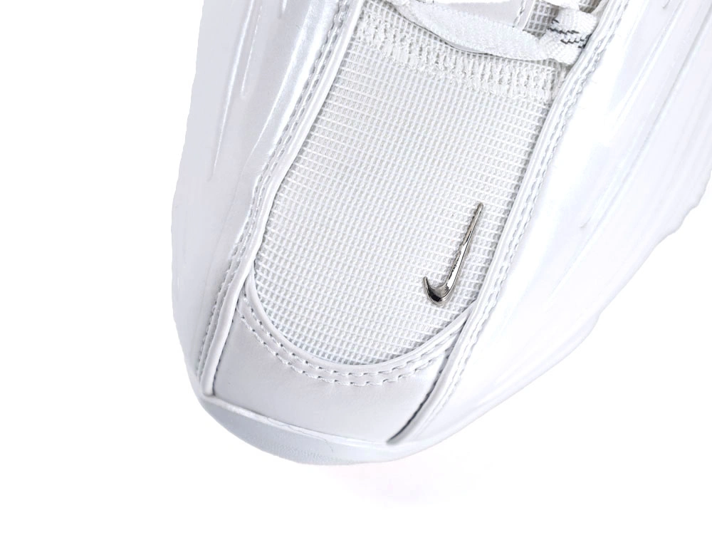 Side profile of sleek all-white sneakers showcasing wavy synthetic overlays and visible Air unit.