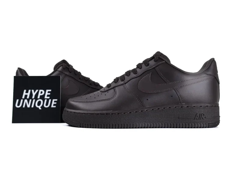 Dark brown leather sneakers with perforated toe box and textured outsole.