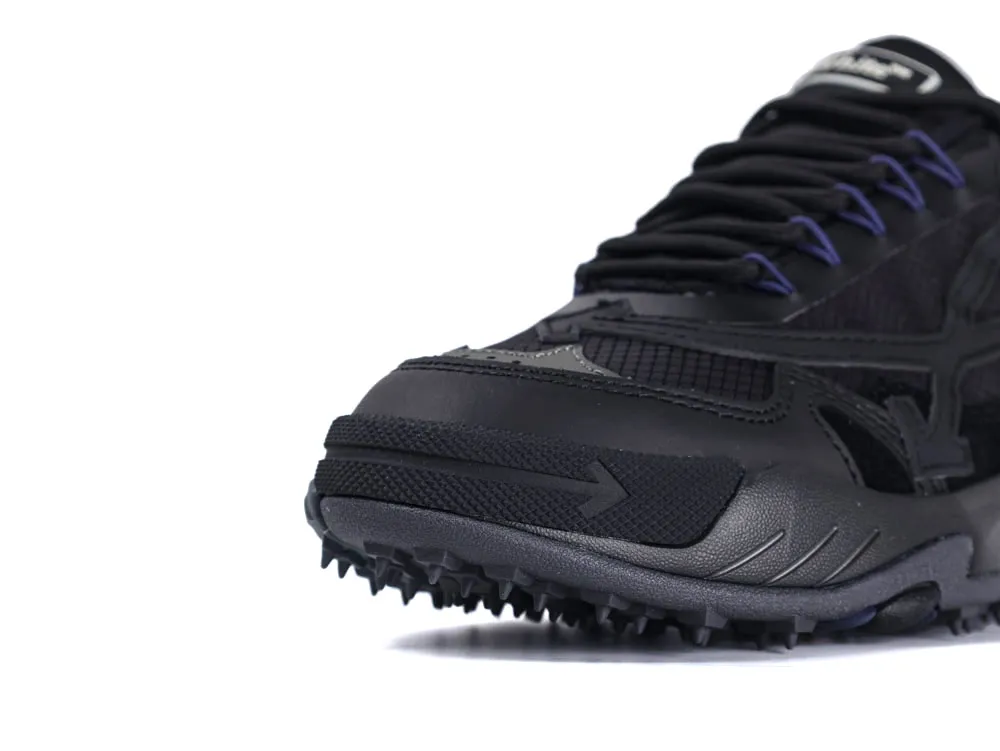 Black sneaker with textured rubber sole and mesh panels, featuring detailed stitching design.