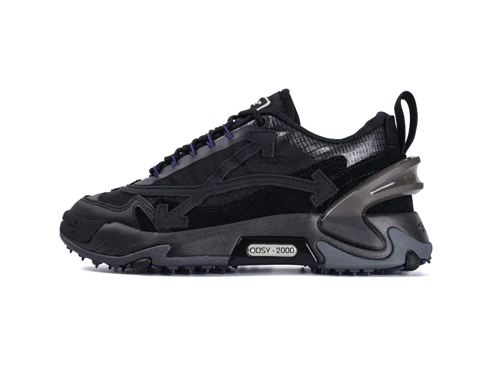 Black sneaker with suede and mesh upper, rubber sole, and decorative stitching.