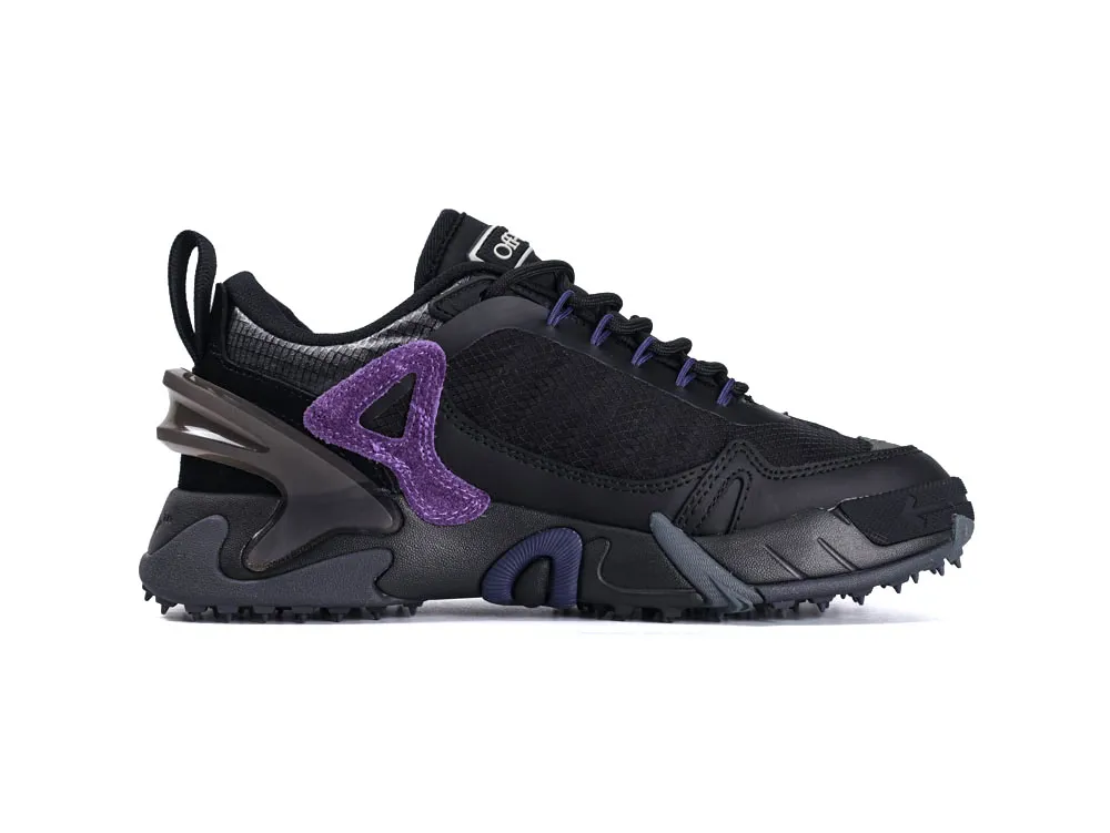 Black sneaker with purple suede accents, mesh upper, and textured rubber sole.