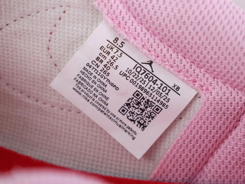 Pink mesh sneaker interior with a woven label displaying size and manufacturing details.
