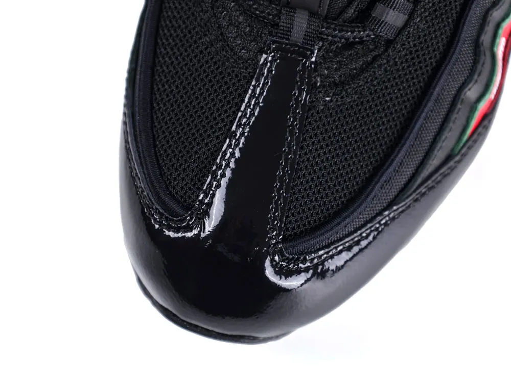 Black patent leather and mesh sneaker toe with reflective finish and colorful detail.