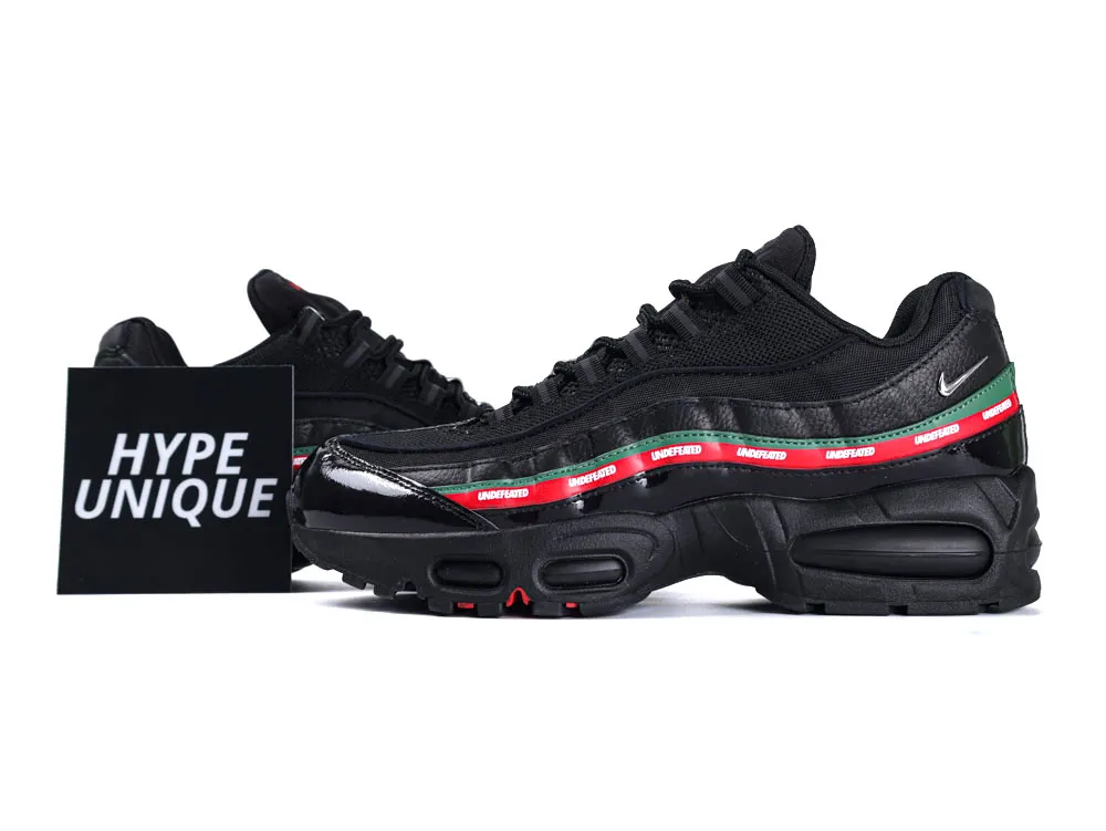 Black sneaker with leather and mesh material, featuring a colorful striped side design.