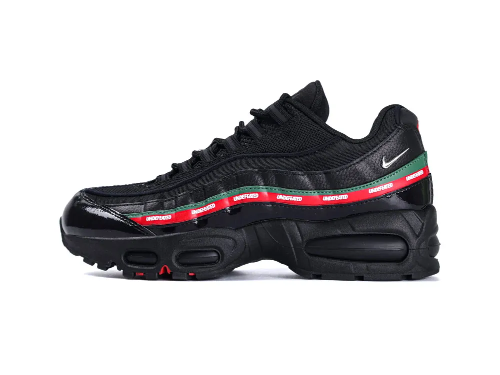 Black sneaker with leather and mesh materials, featuring colorful branding and a cushioned sole.
