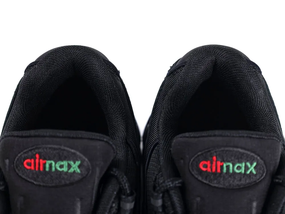 Black fabric shoe tongue with "airnax" logo in red and green letters.