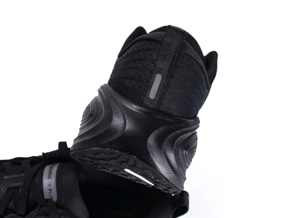 Black fabric and rubber sneaker heel, featuring a textured design and pull tab.