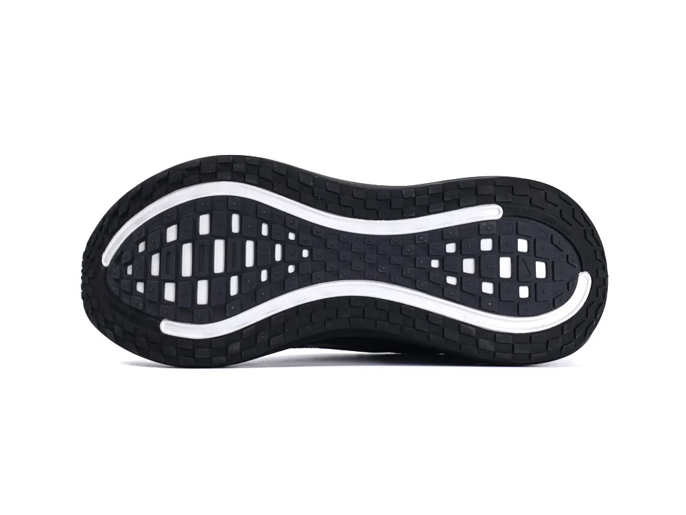 Black rubber shoe sole featuring white accents and textured grip pattern.