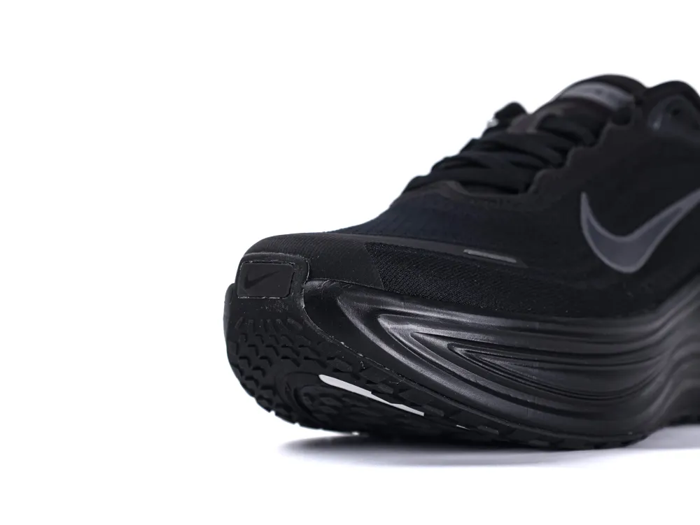 Black sneaker with mesh material and rubber sole, featuring a sleek Nike logo.